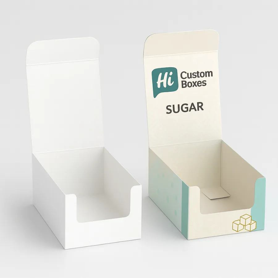 Two open cardboard display boxes for sugar- one plain white and one with blue branding- class=
